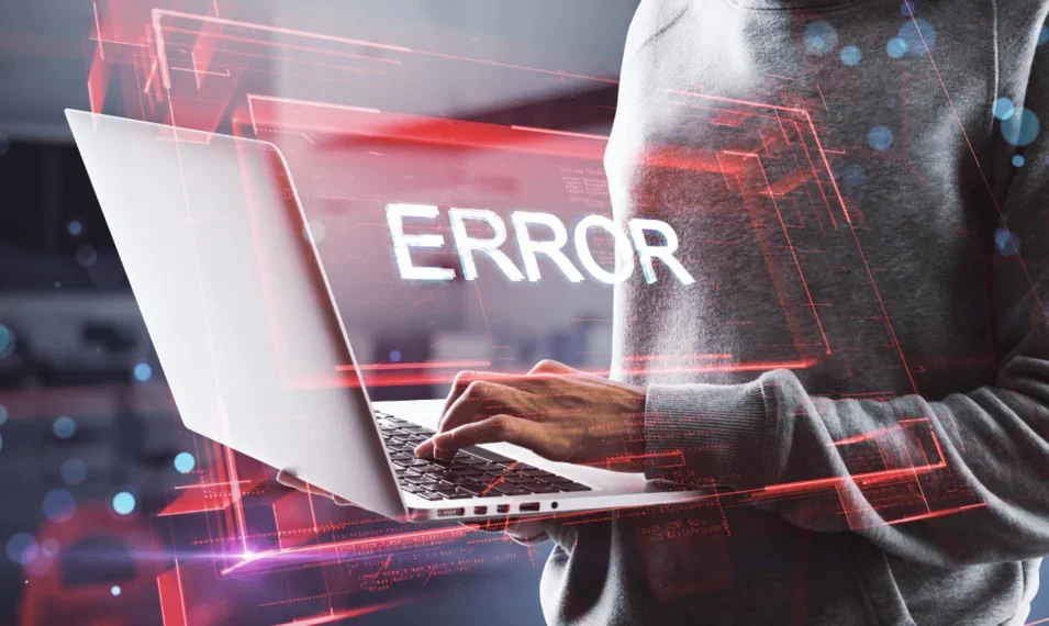 Error message glowing while person uses a laptop